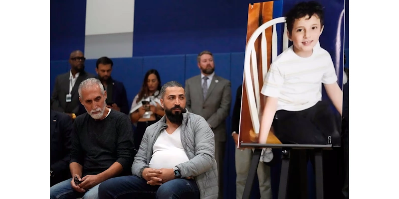 Wadea Al-Fayoume's father, Oday Al-Fayoume, right, and his uncle Mahmoud Yousef attend a vigil for Wadea at Prairie Activity and Recreation center in Plainfield, Ill., on Oct. 17.